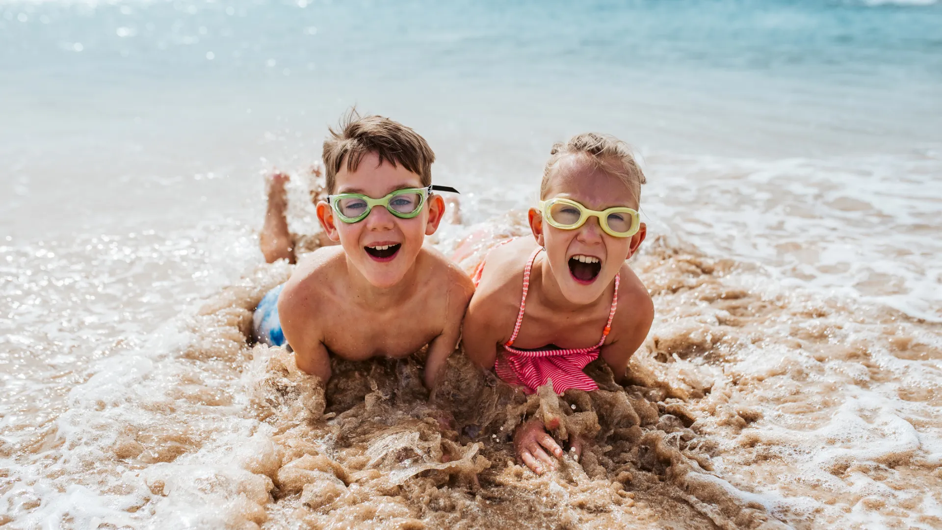 Kids play in the water at the beach