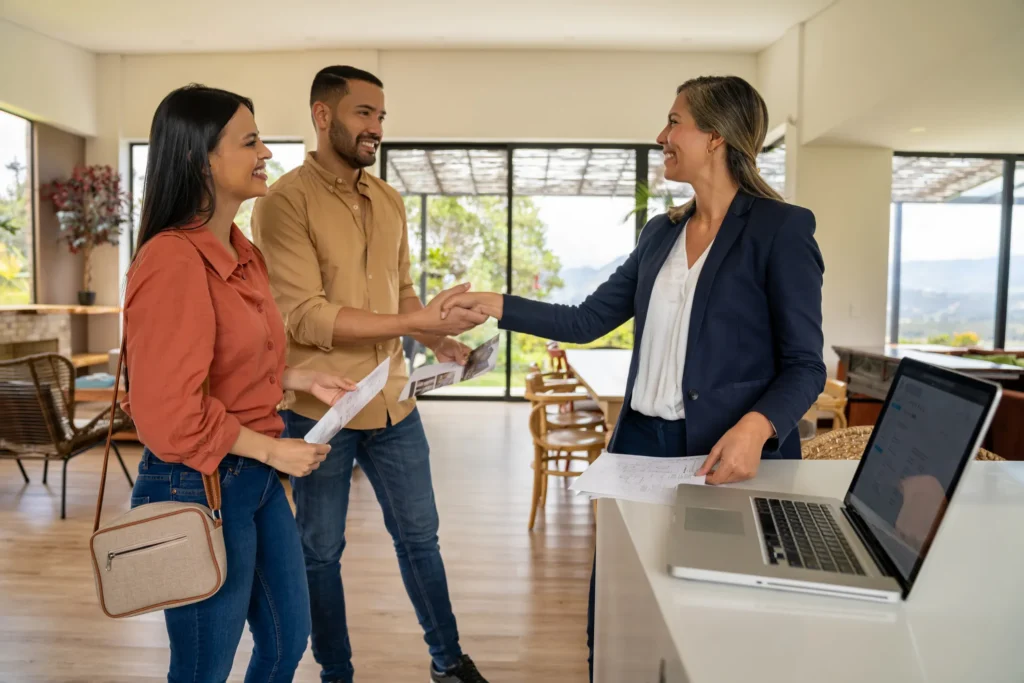An agent adept at the Triangle real estate market shakes hands with a couple who are looking at a home for sale.