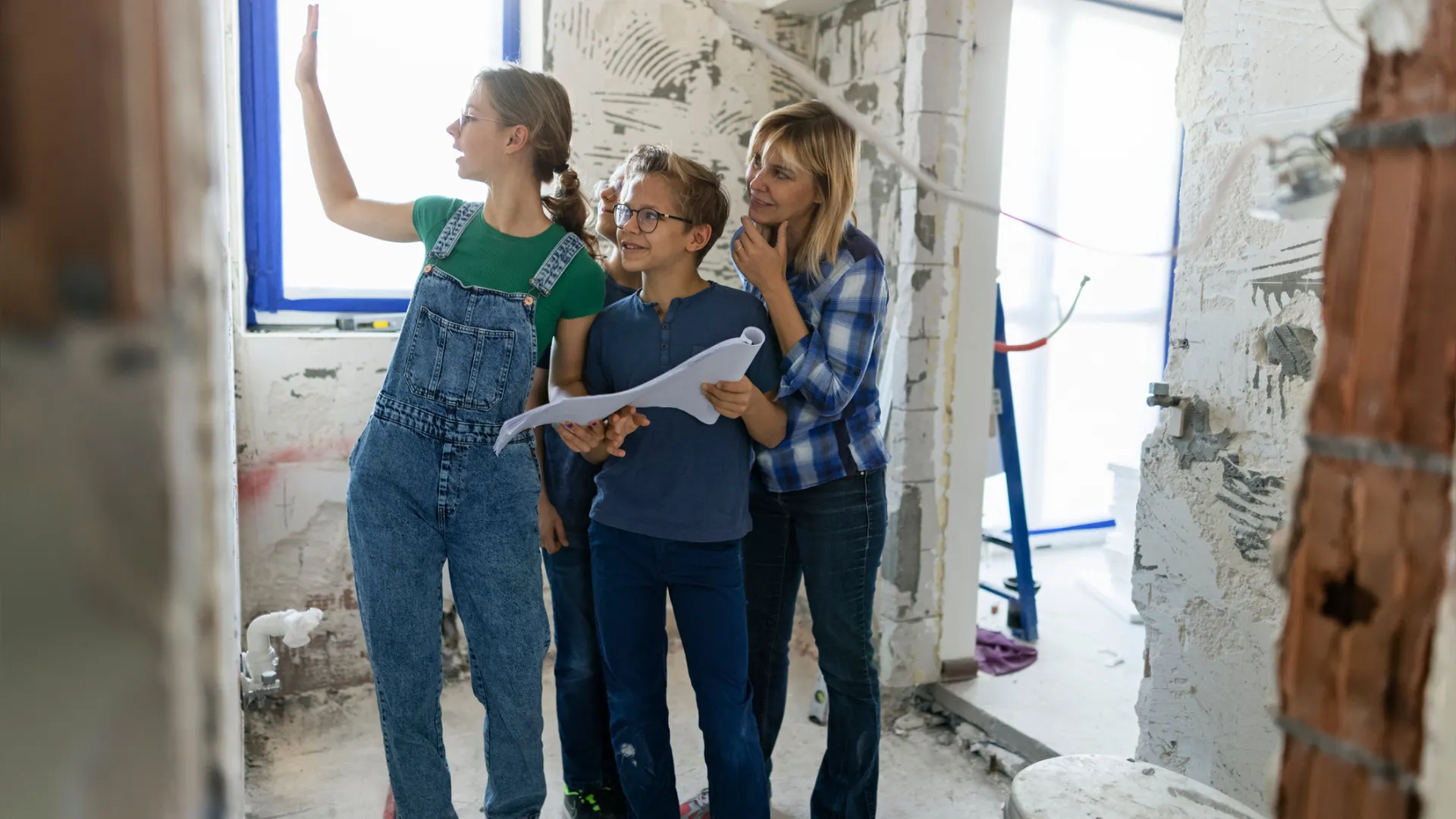 A family looks at bathrooms plans after discussing the cost of adding a bathroom to their home