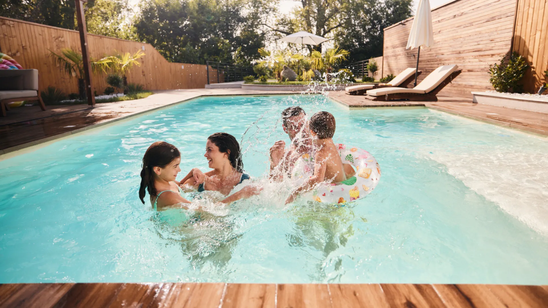 A family of four swim at home after they learned the smart way to buy a home with a pool