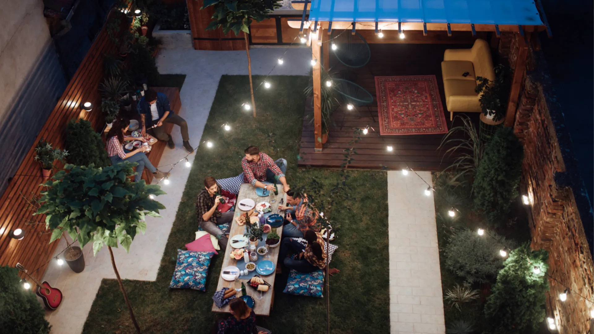 A group of friends hang out in a stunning backyard living space