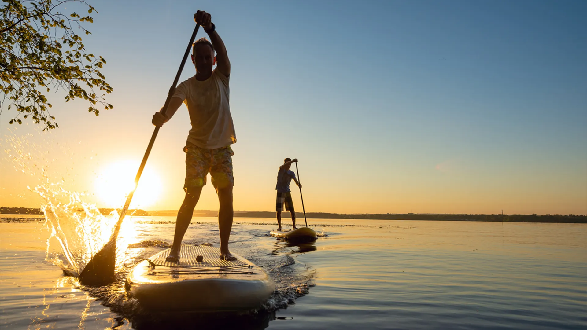 Friends go stand up paddle boarding, which is a great way to make the most of a long Labor Day weekend in the Triangle