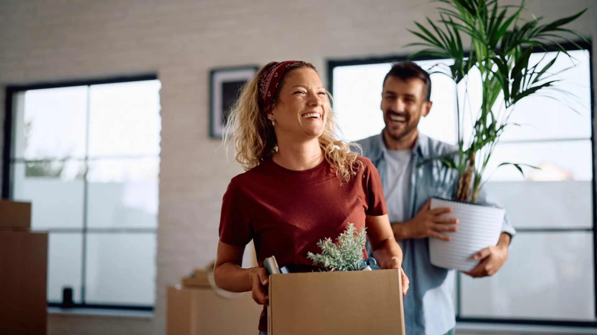 A young couple smiles together as they move into a new home. How to compete in a low-inventory market: Triangle-area real estate tips