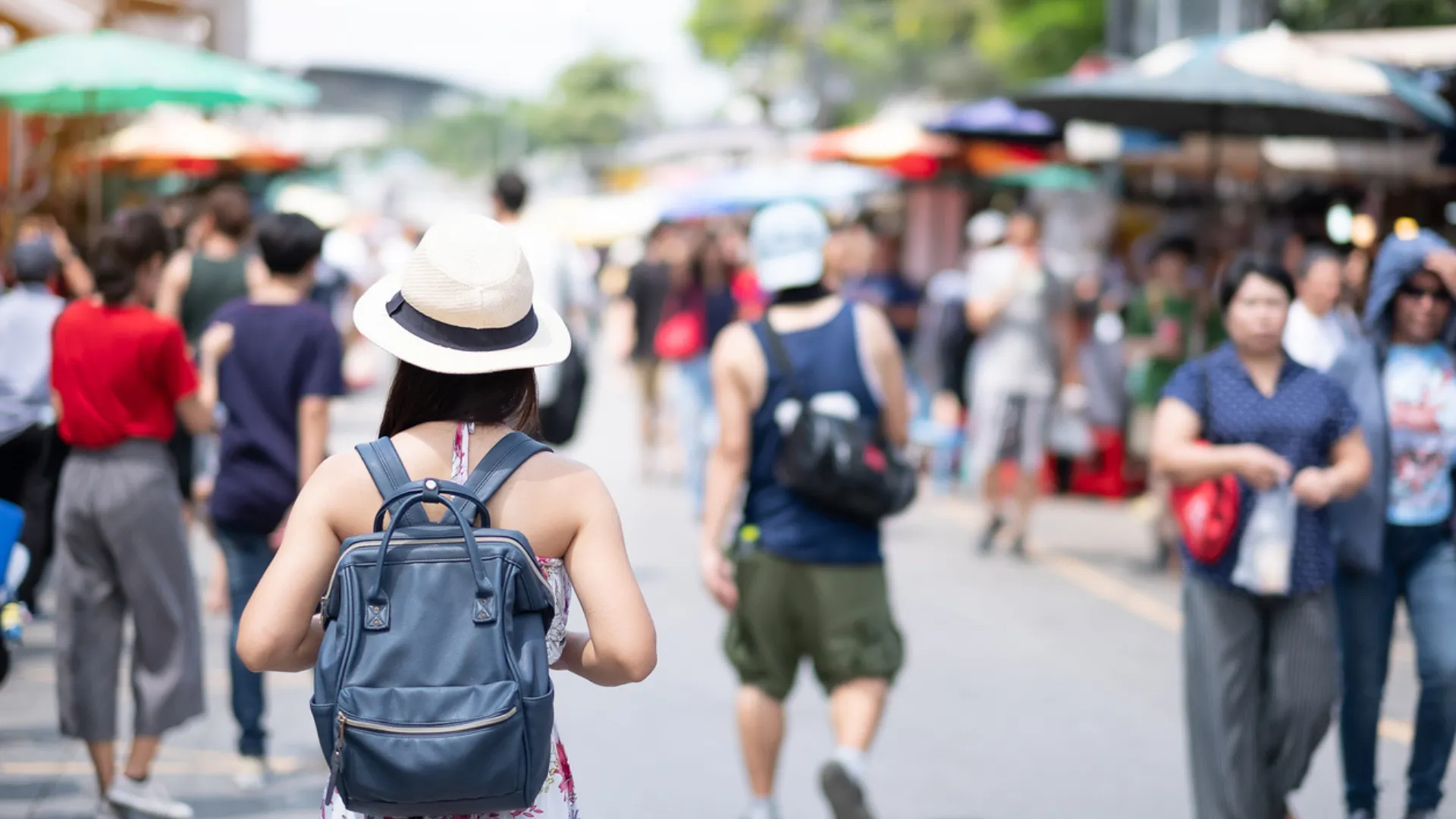 A woman walks down the street at a small town fair in one of the best suburbs for families and young professionals in the Triangle