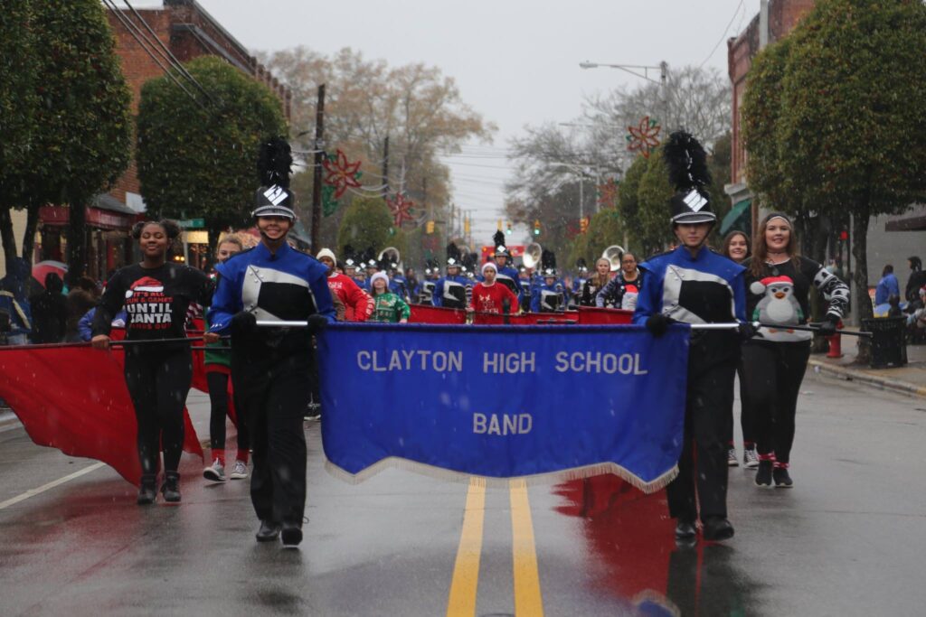 The Clayton High School marching band marches during a holiday parade.