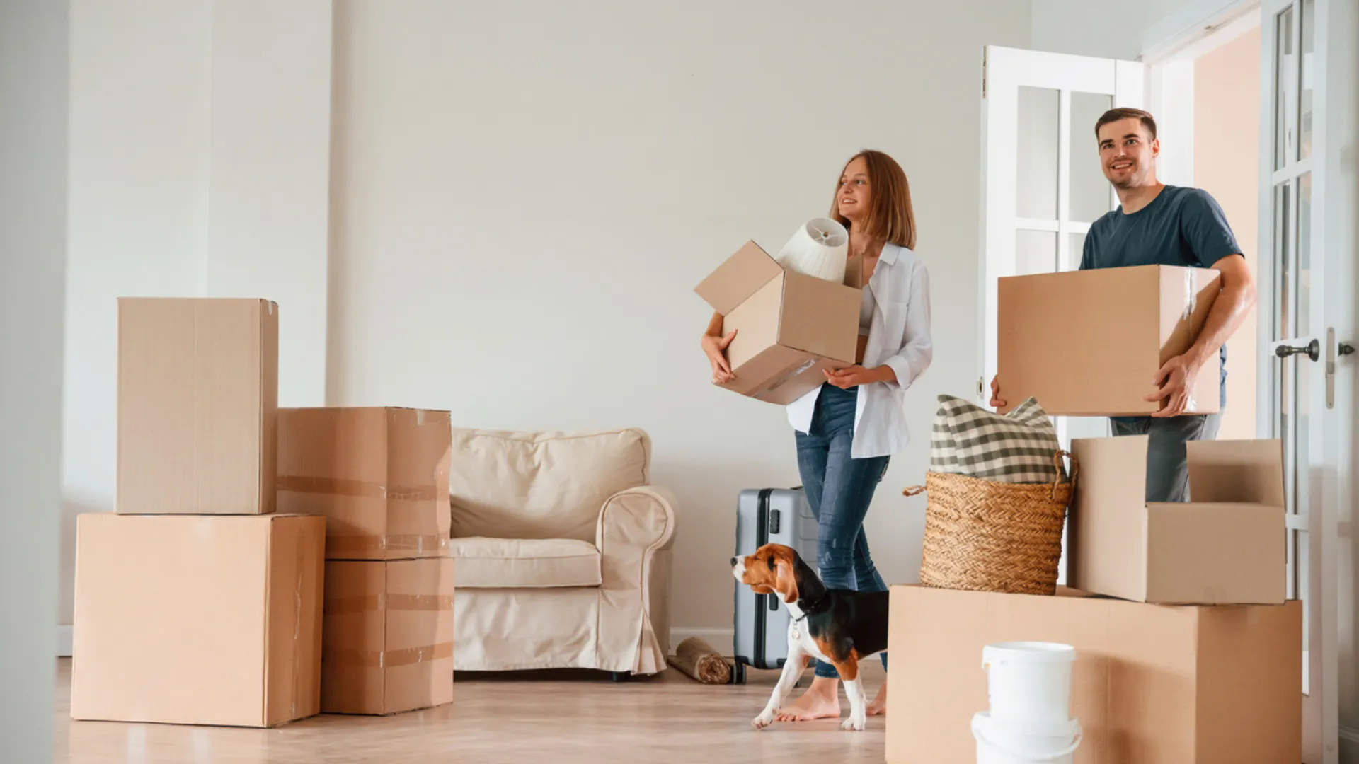 A couple moves boxes into their home after moving to North Carolina
