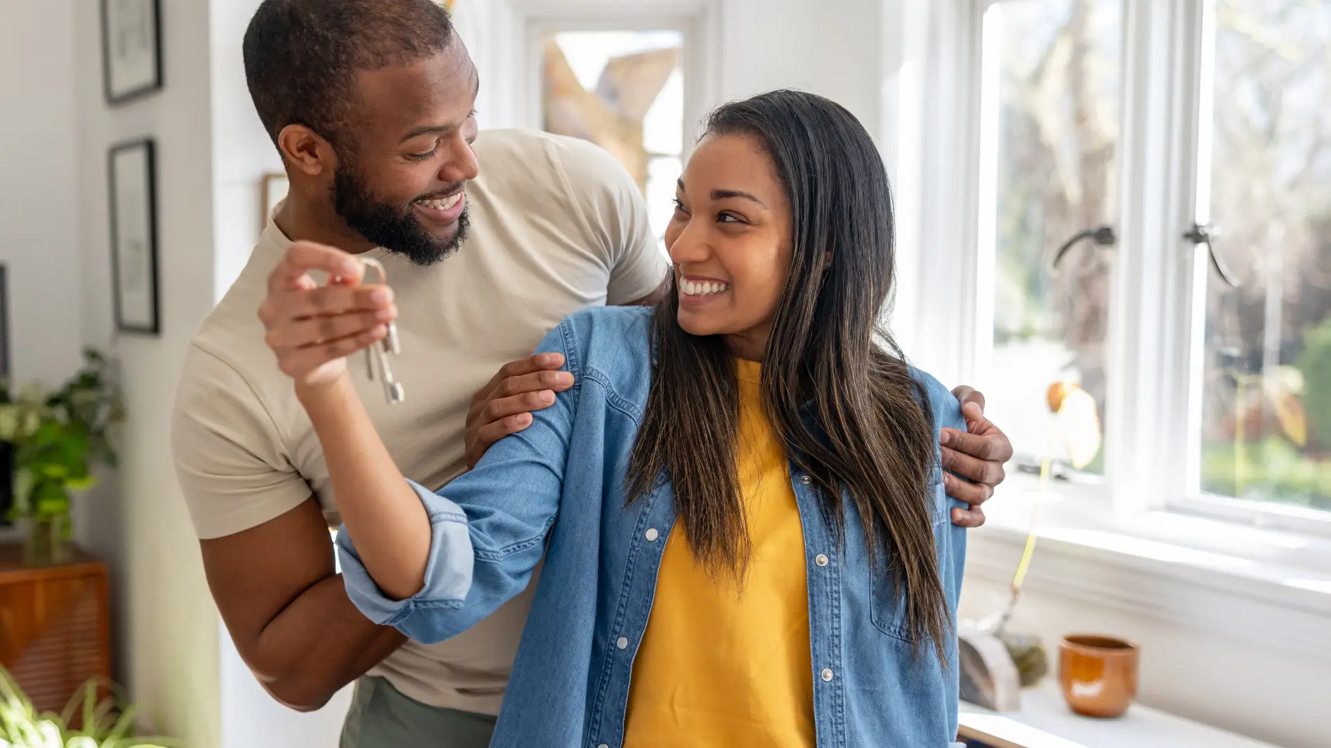 A couple smile at each other after getting tips for North Carolina Homebuyers looking to compete in a low-inventory housing market