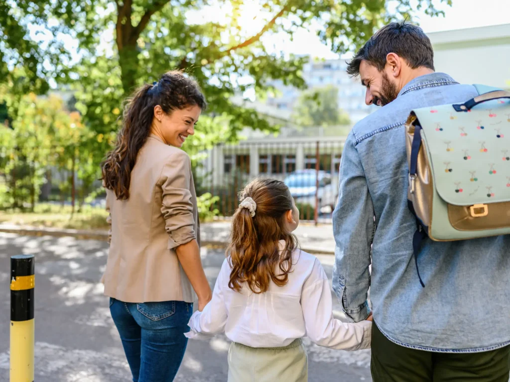 A mother and father walk their daughter to one of the Charter schools in the Triangle