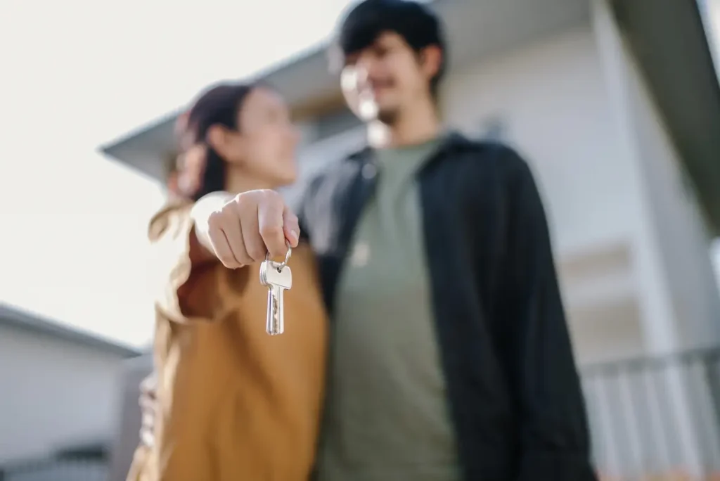 A couple holds the keys to their first home after taking advantage of Triangle first-time homebuyer porograms